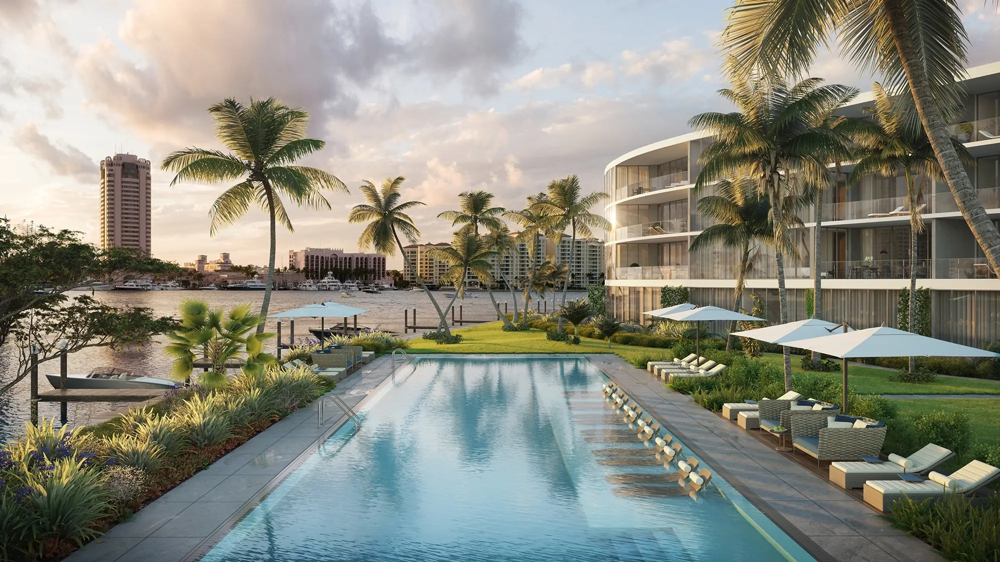 The lakefront pool and palms at Boca Beach House, with the curved building beyond