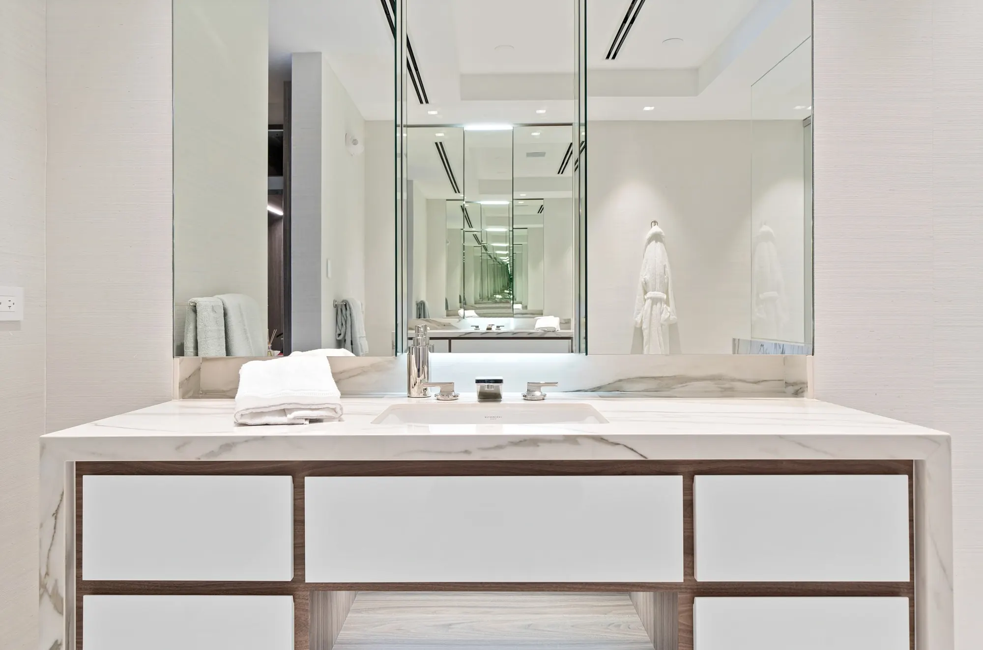 Vanity with marble top and mirrored cabinets