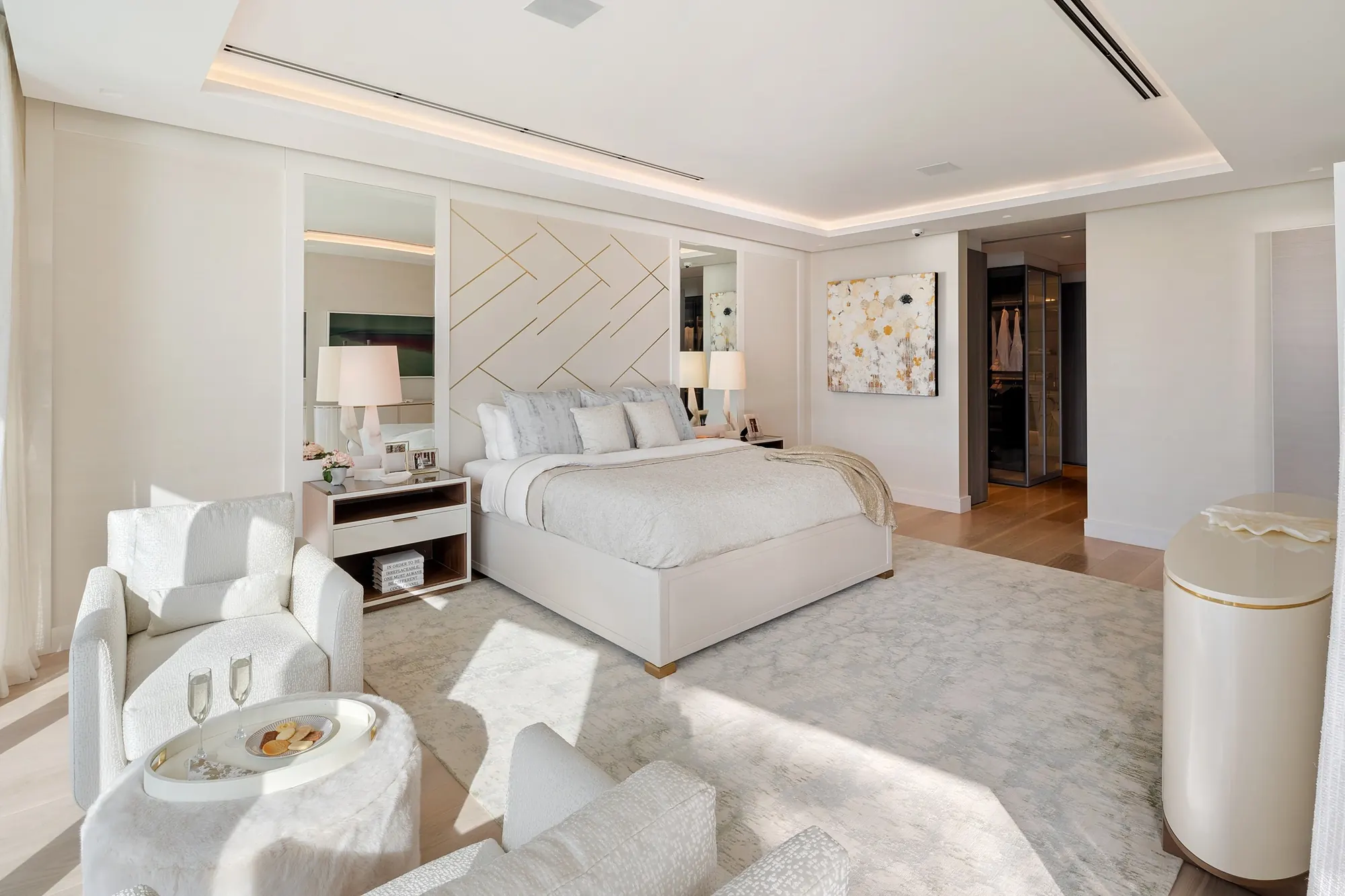Bedroom with upholstered headboard and sitting area