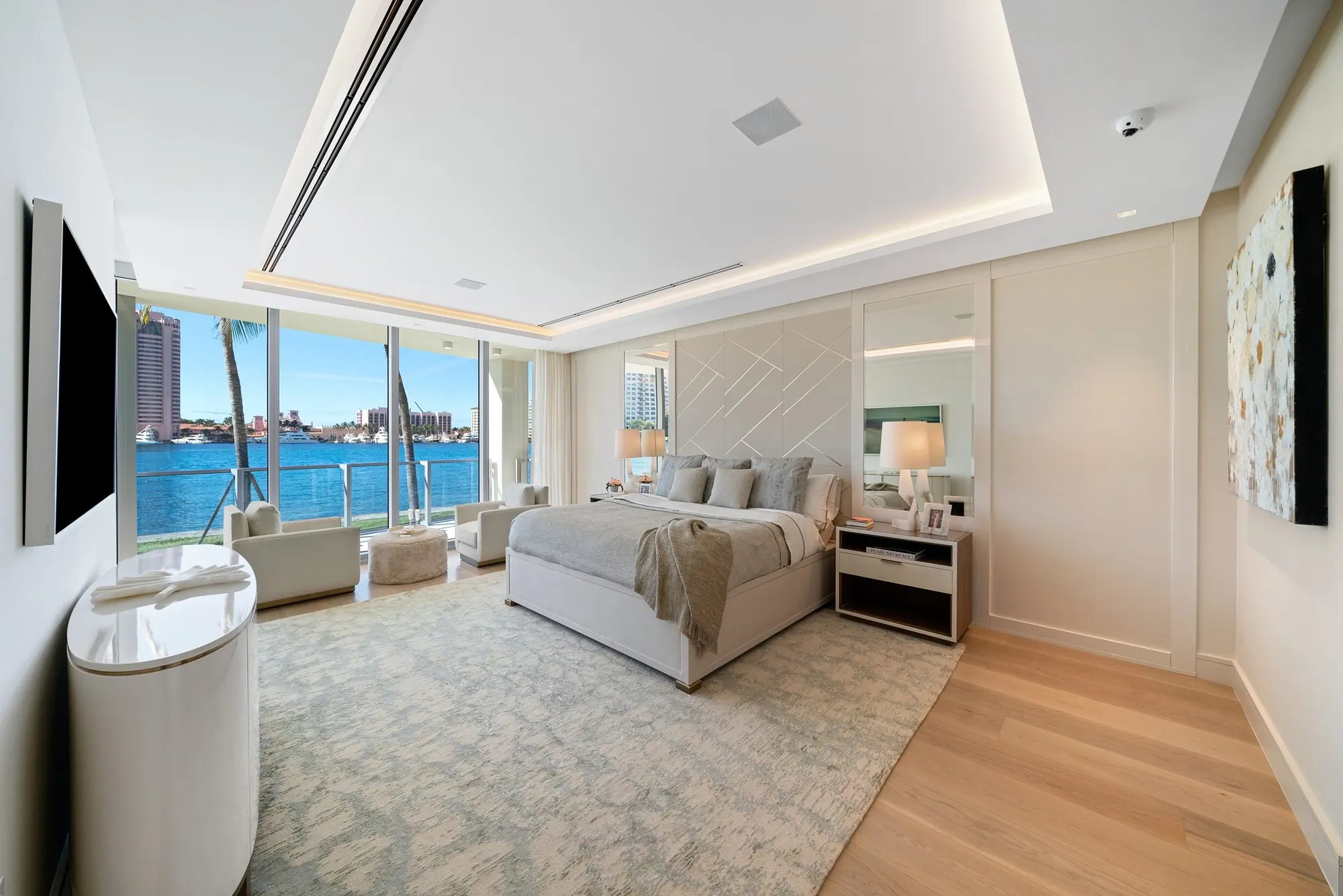 Bedroom with water views and a TV wall