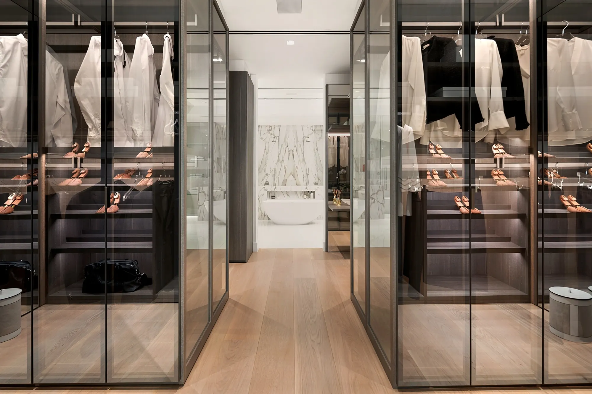 Walk-in dressing room with glass-front wardrobes