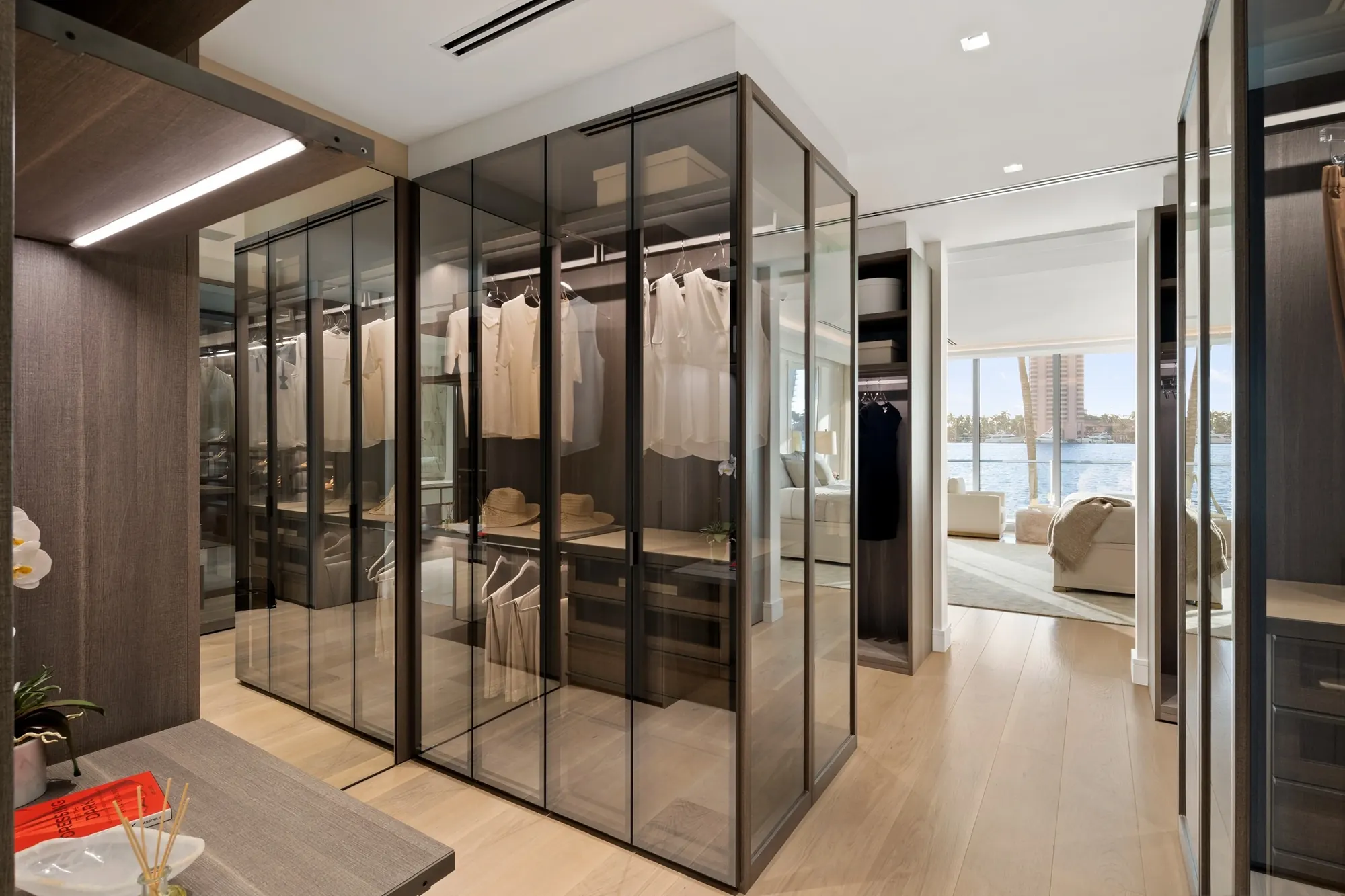 Dressing room with glass and bronze-framed cabinetry