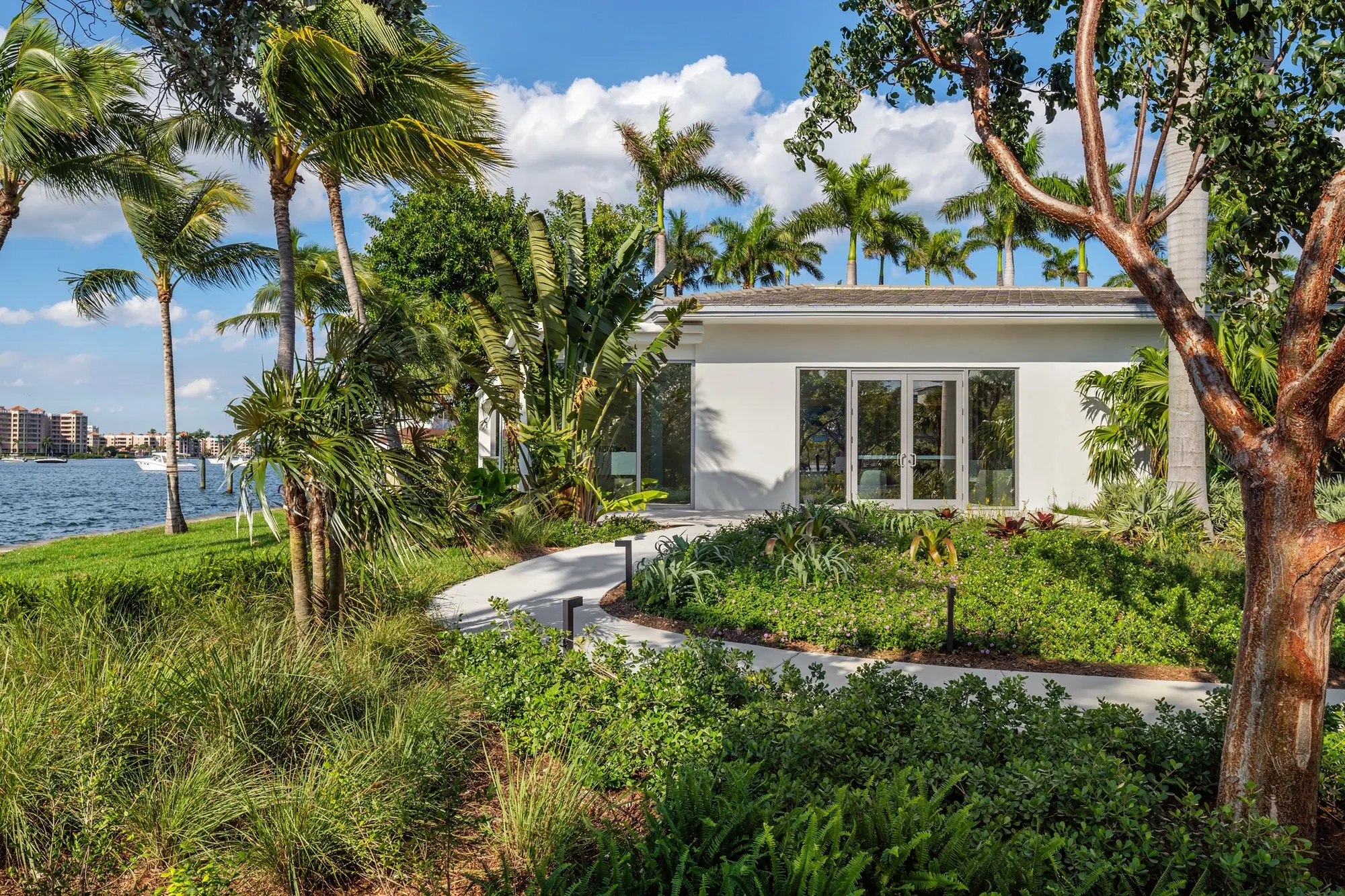 Tropical landscaping along the water at the Boca Beach House site
