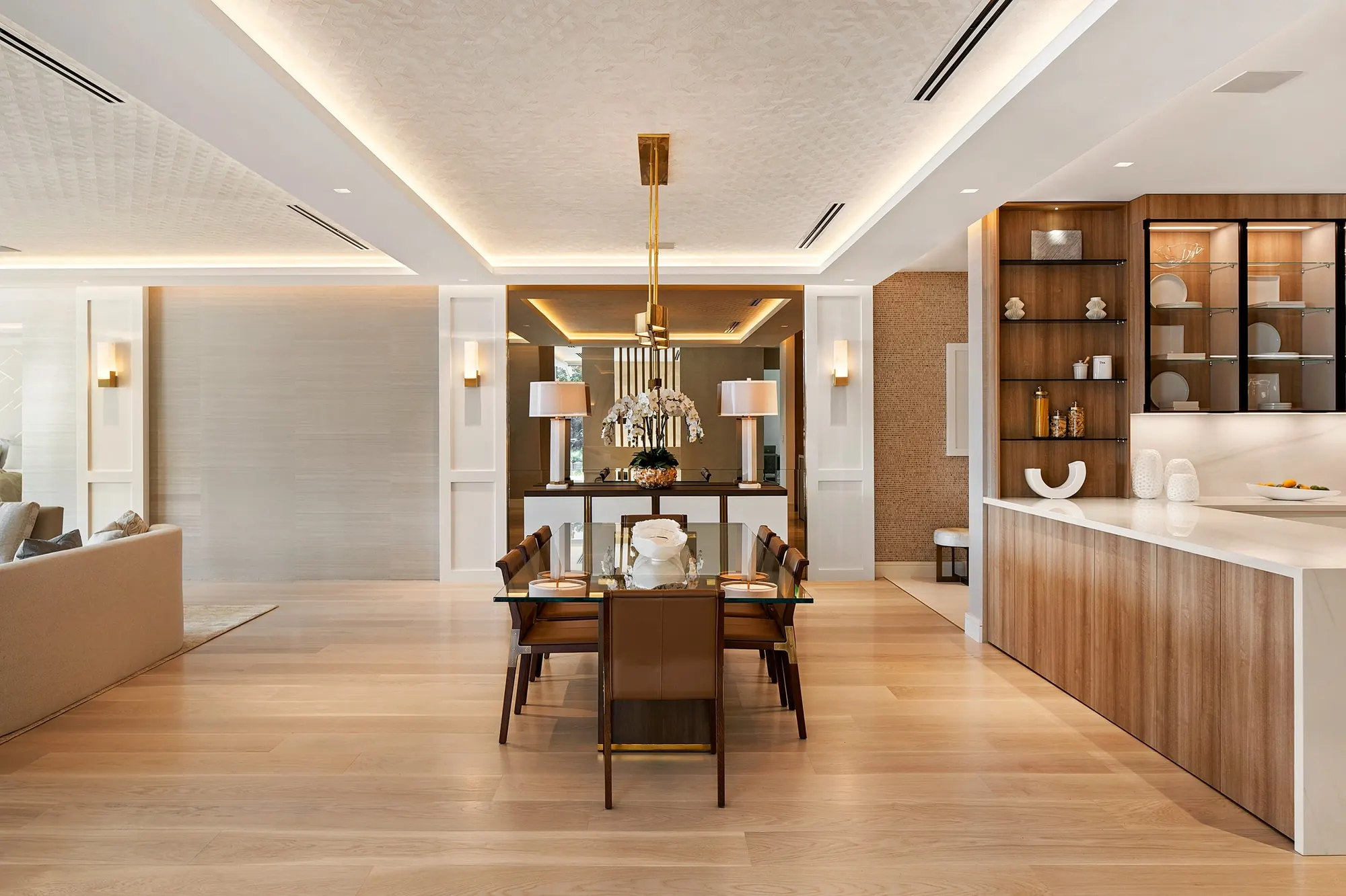 Open dining area and kitchen with warm wood cabinetry
