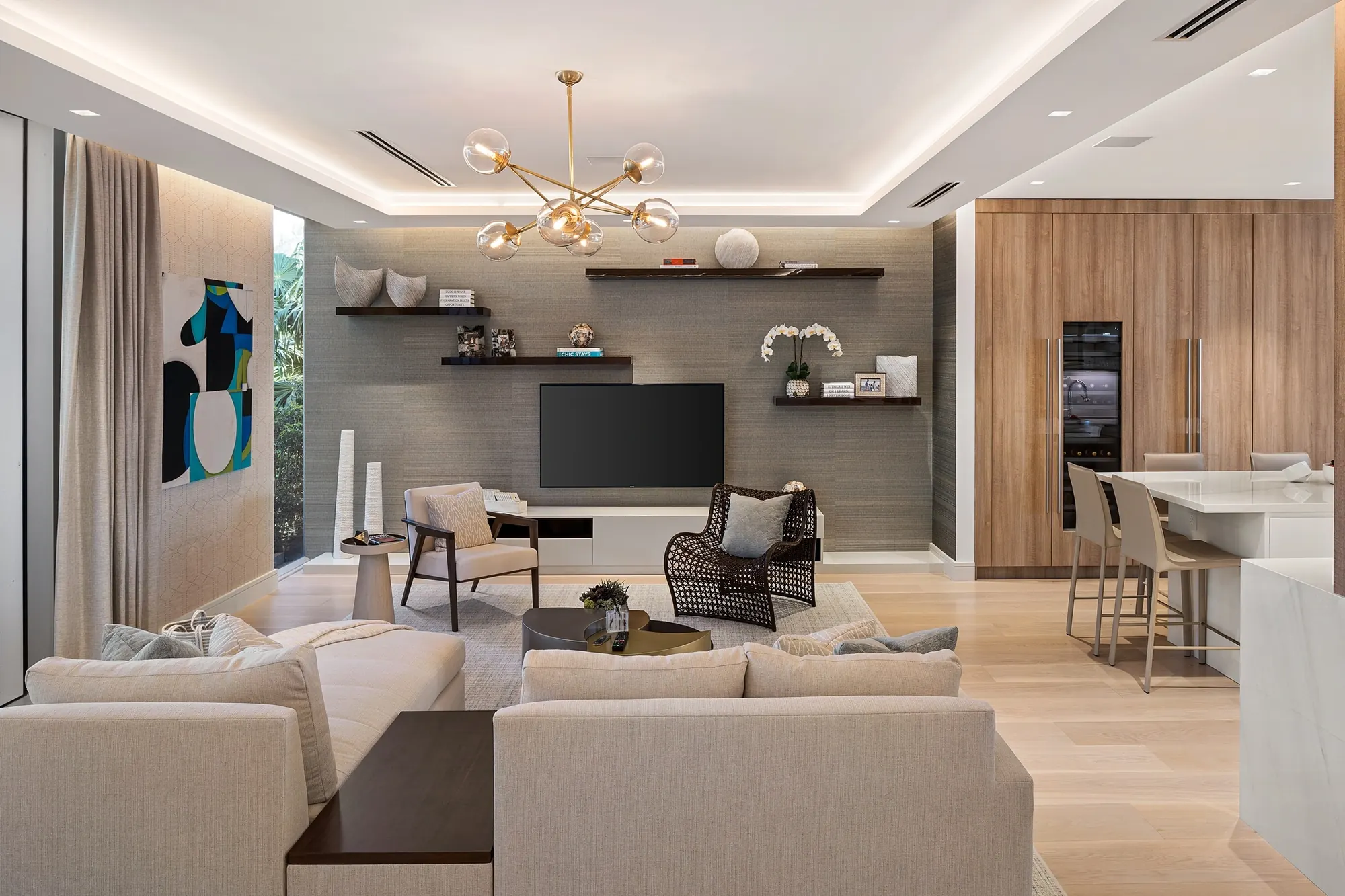 Living area with media wall and dining beyond