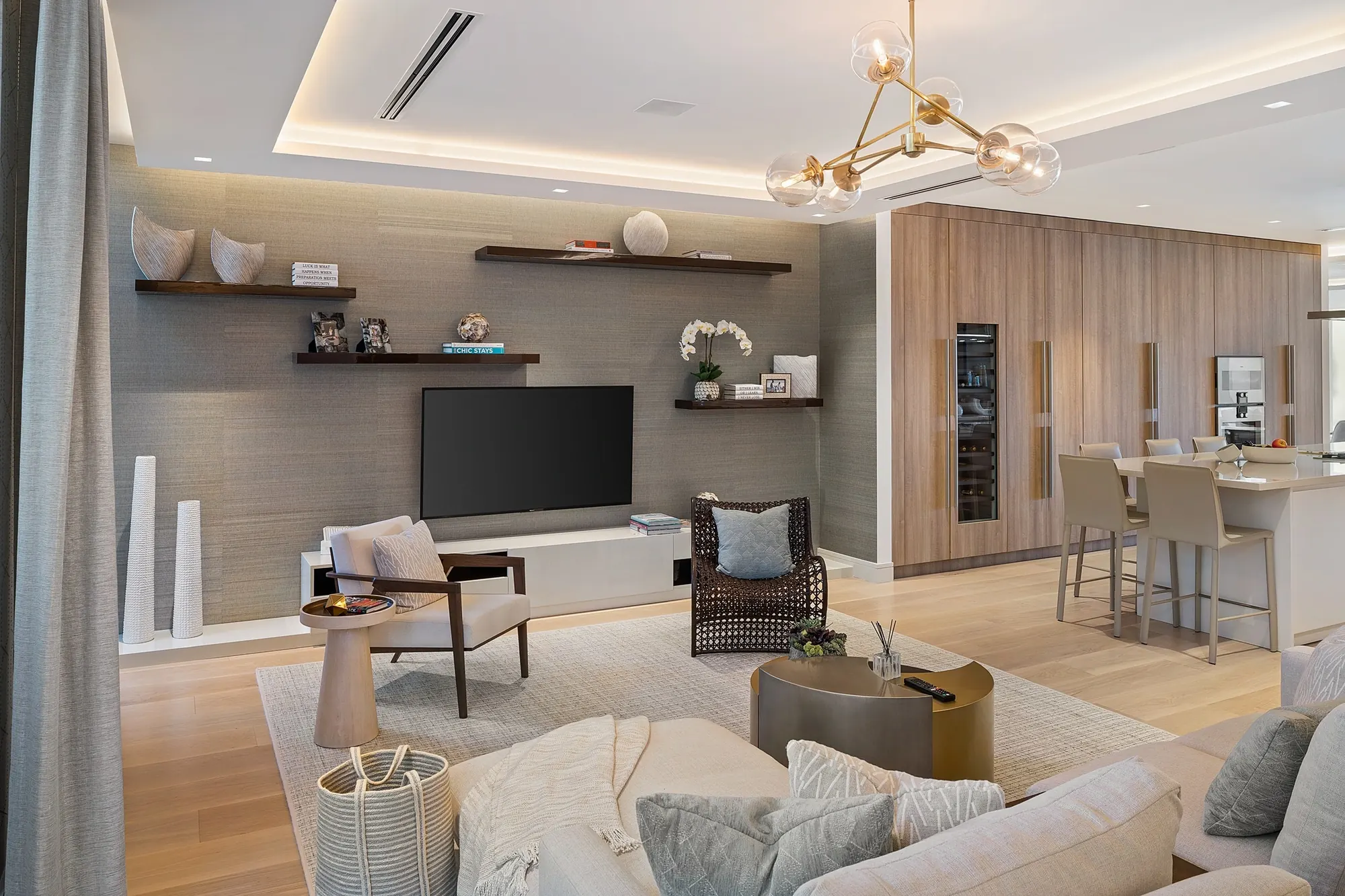 Living room with media wall and kitchen counter seating