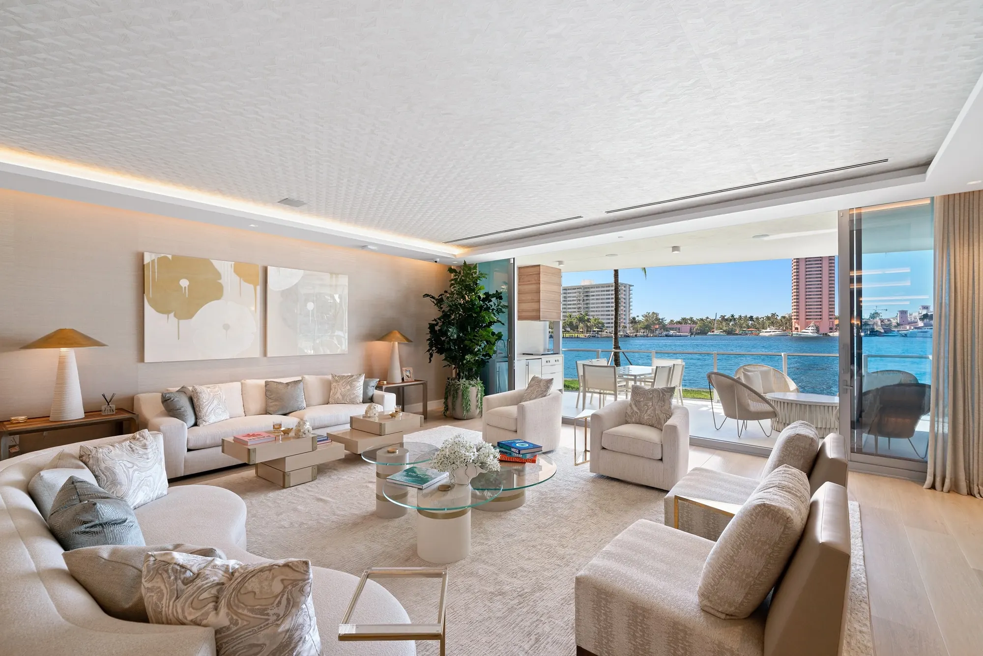 A living room at Boca Beach House opening onto a terrace above Lake Boca Raton